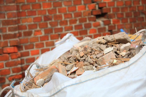 Workers segregating wood and metal waste on a building site